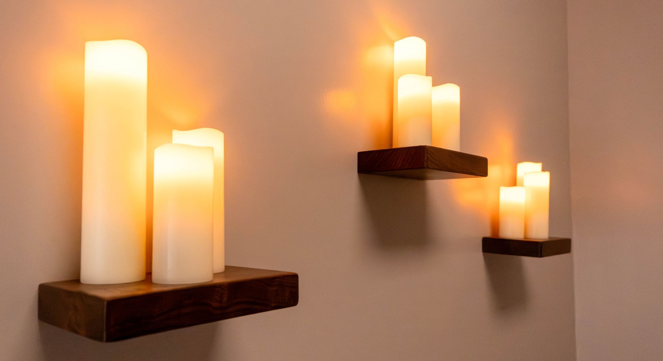 candles on shelves on a wall